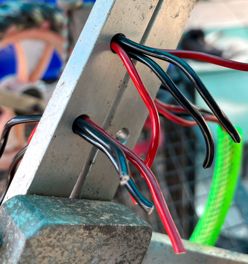 Cables threaded through frame to install the back leg support