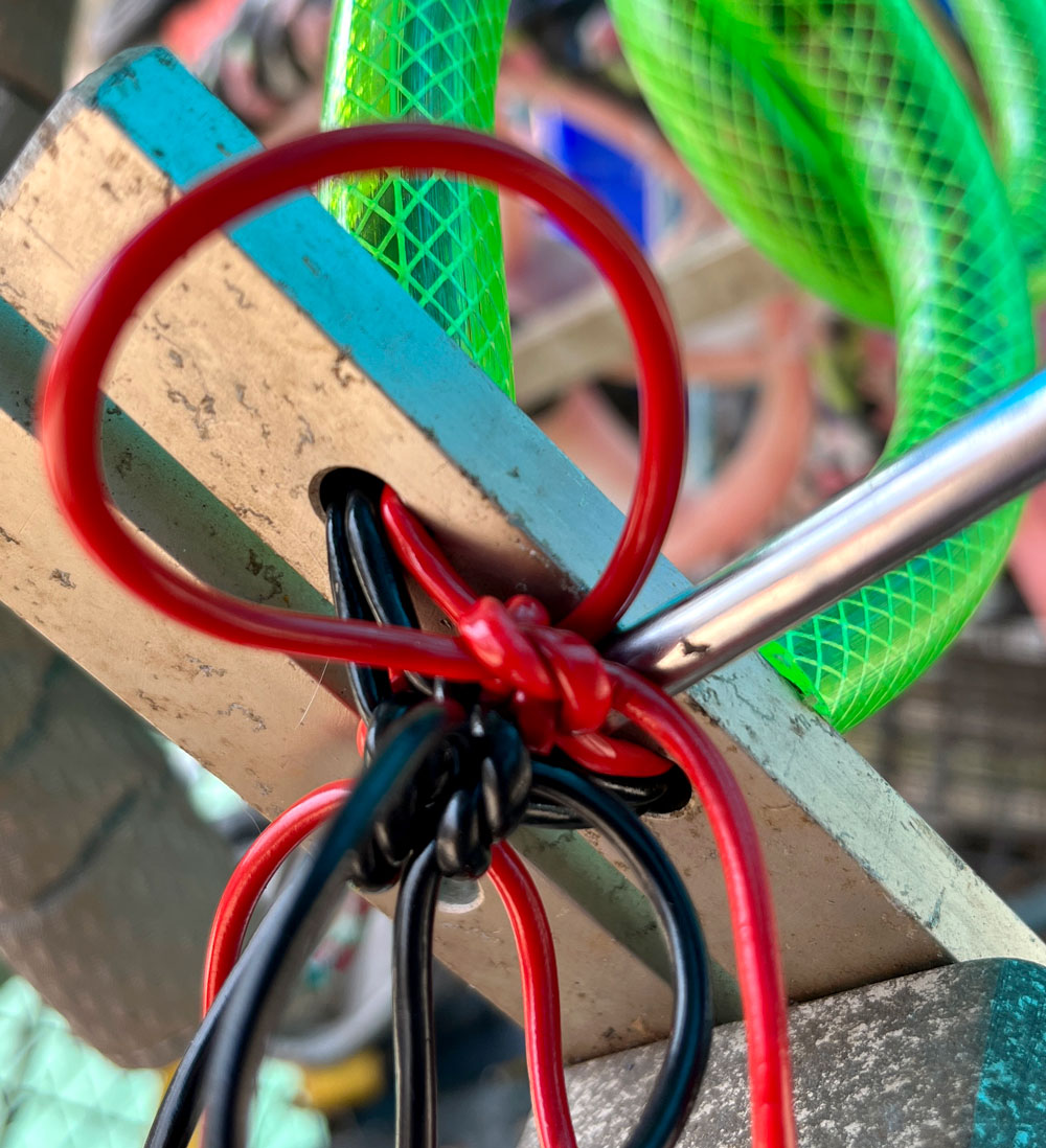 Poking the cables behind the knots